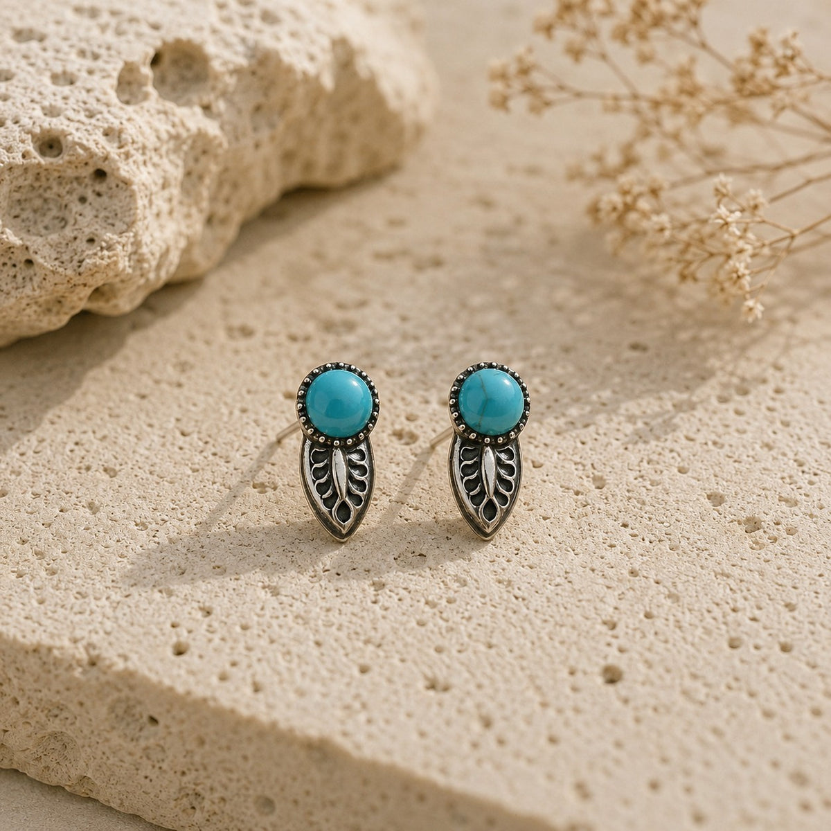 SOWELL JEWELRY Angelica turquoise stud earrings featuring a round stone set in a sterling silver leaf design.