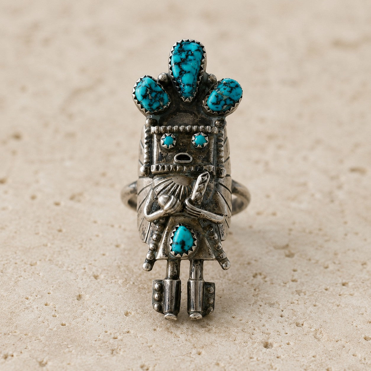 SOWELL JEWELRY antique sterling silver ring featuring a sculptural Kachina doll motif with spiderweb turquoise stones.