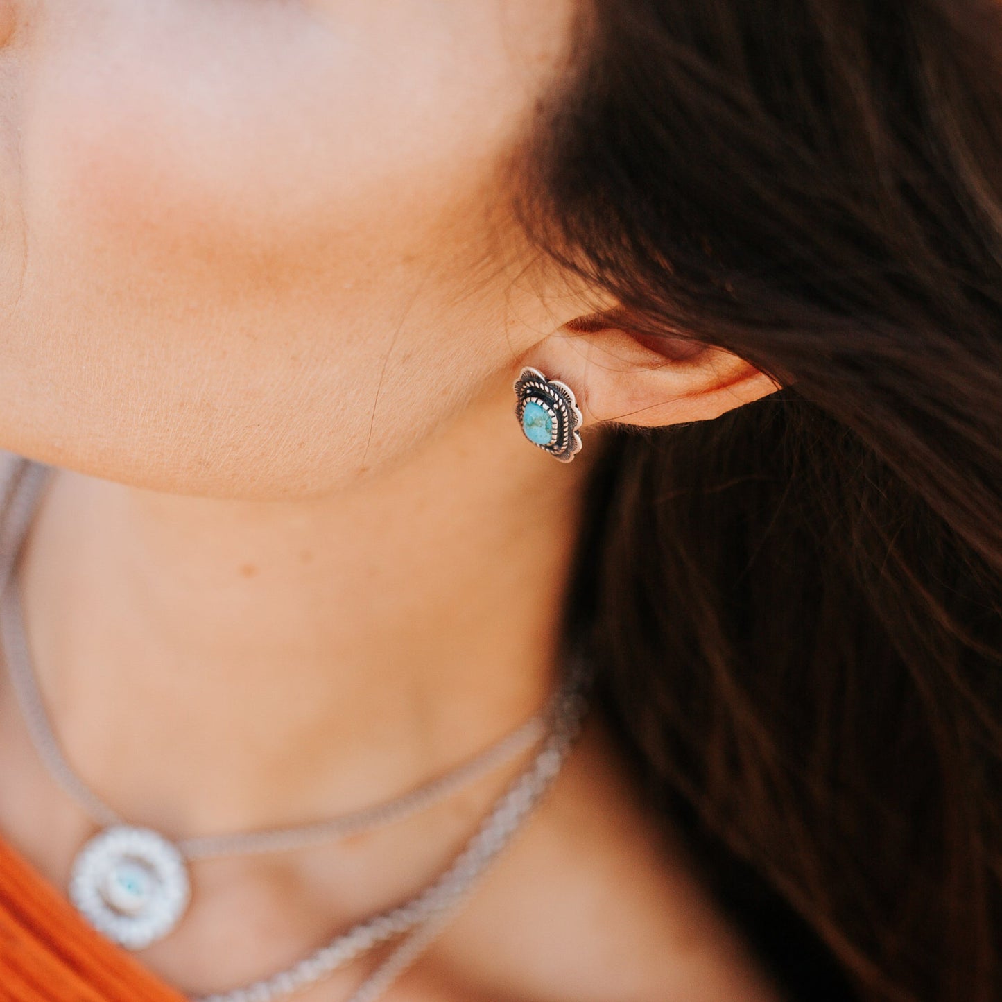 SOWELL JEWELRY Asia earrings featuring cushion-shaped turquoise stones in sterling silver settings worn on a model.