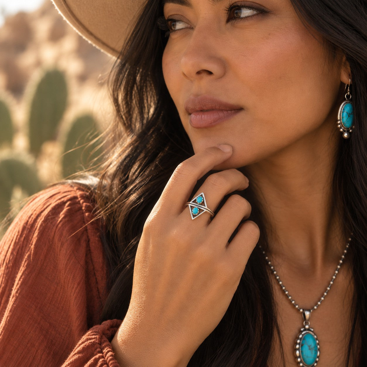 SOWELL JEWELRY Aurelia ring featuring two turquoise stones in geometric oxidized sterling silver triangles on a model
