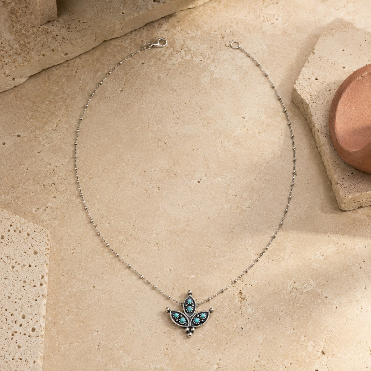 SOWELL JEWELRY cactus flower necklace with turquoise stones and oxidized sterling silver petals on a ball chain.