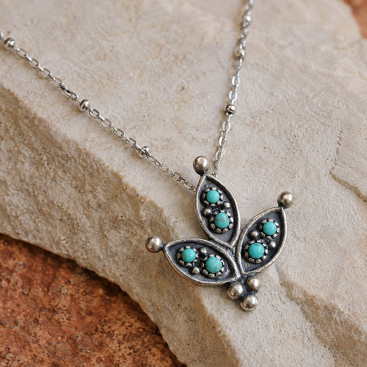 SOWELL JEWELRY cactus flower necklace featuring genuine turquoise stones set in oxidized sterling silver petals.