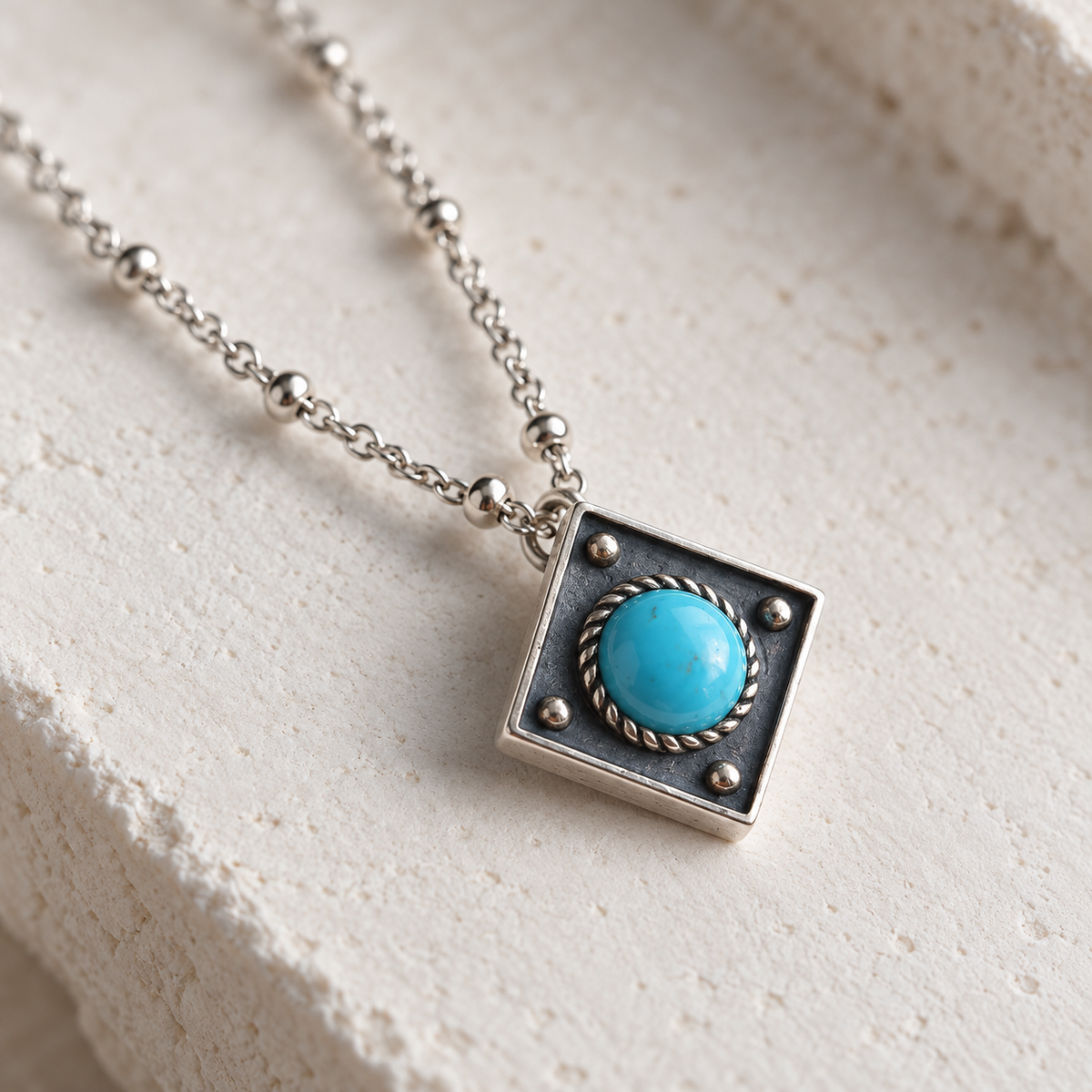 SOWELL JEWELRY Catalina turquoise necklace featuring a round stone in a diamond-shaped oxidized sterling silver pendant
