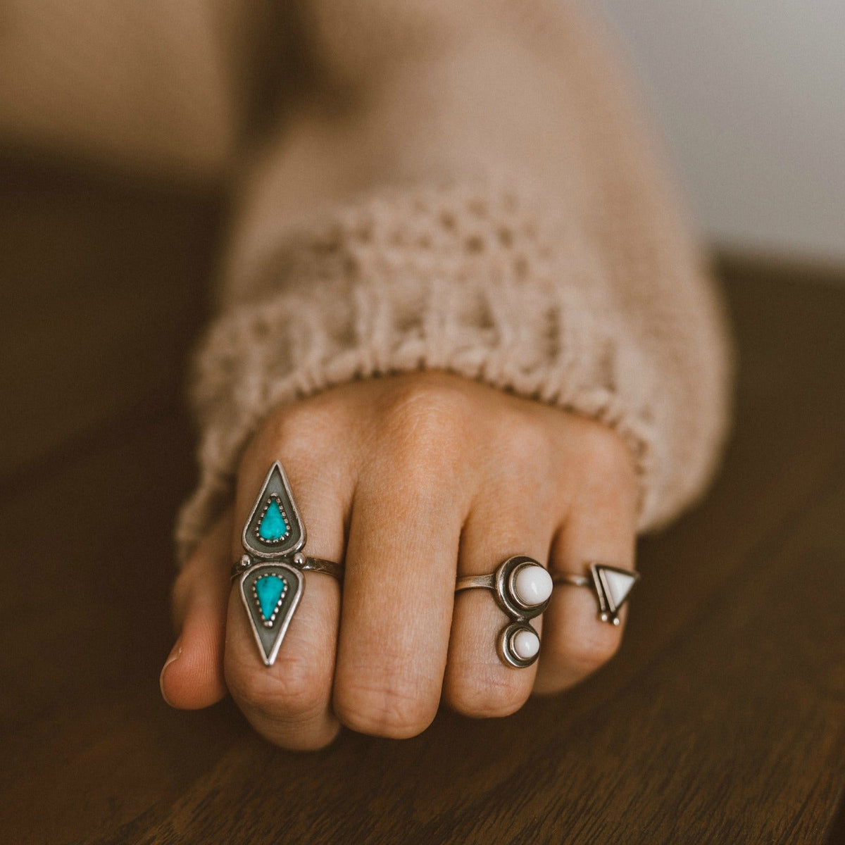 SOWELL JEWELRY Elan turquoise ring featuring a pear-shaped stone on an adjustable sterling silver band on a hand