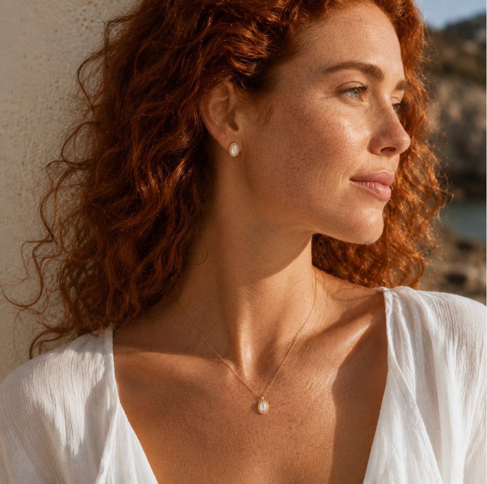 SOWELL JEWELRY Fala oval mother of pearl stud earrings in 18k gold vermeil worn by a woman with red hair