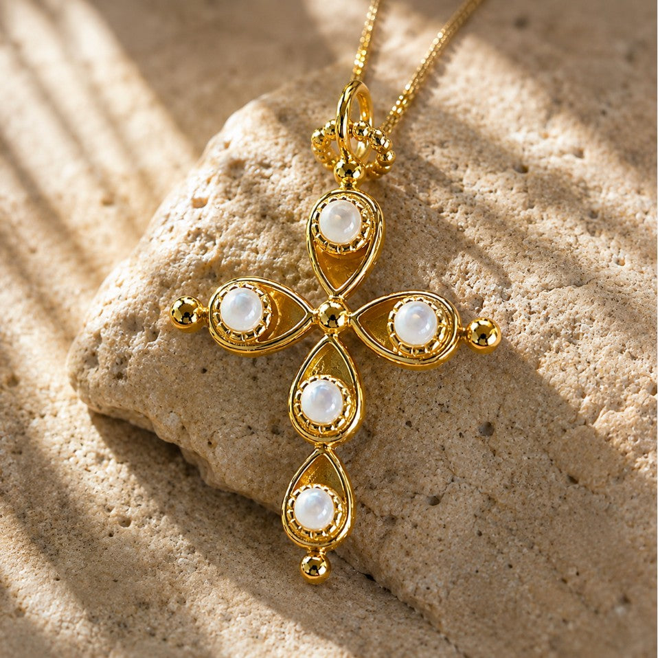 SOWELL JEWELRY 18k gold plated cross pendant necklace featuring inlaid iridescent mother of pearl stones on a rock.