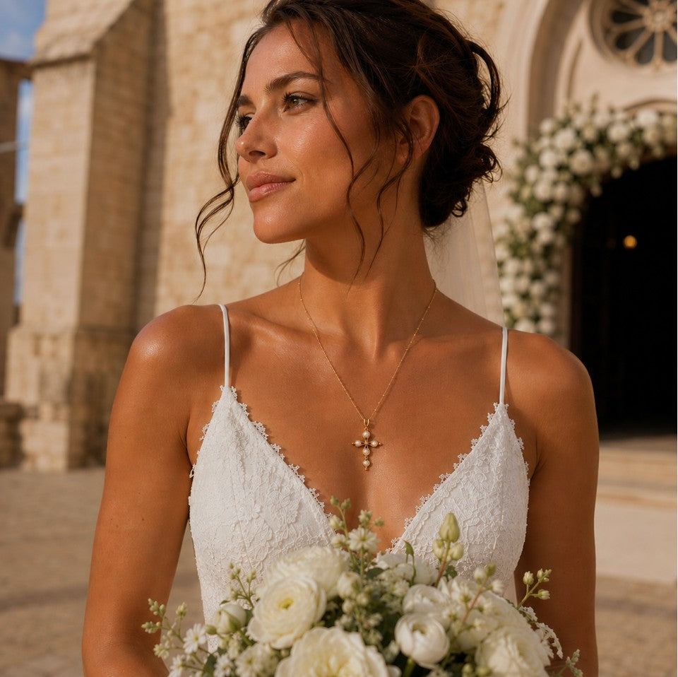 SOWELL JEWELRY 18k gold cross necklace with mother of pearl inlay worn by a bride in a white lace wedding dress