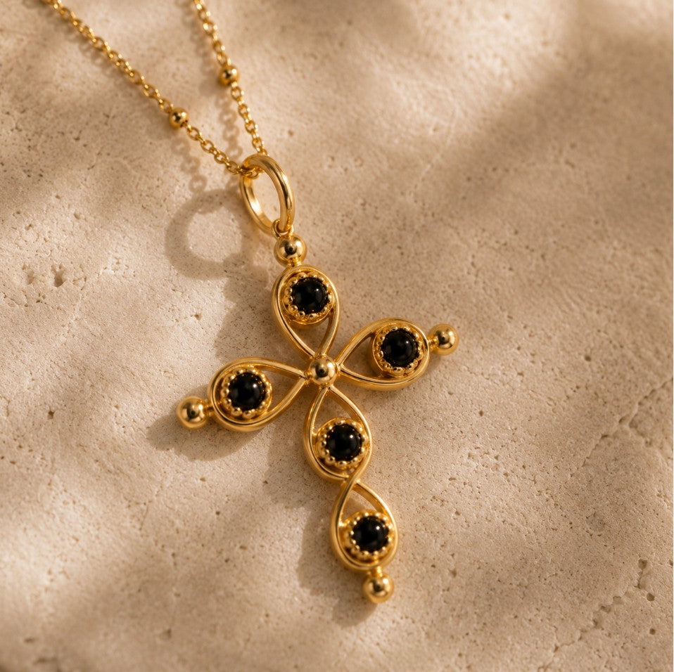 SOWELL JEWELRY 18k gold-plated cross pendant featuring black onyx stones on a delicate gold ball chain