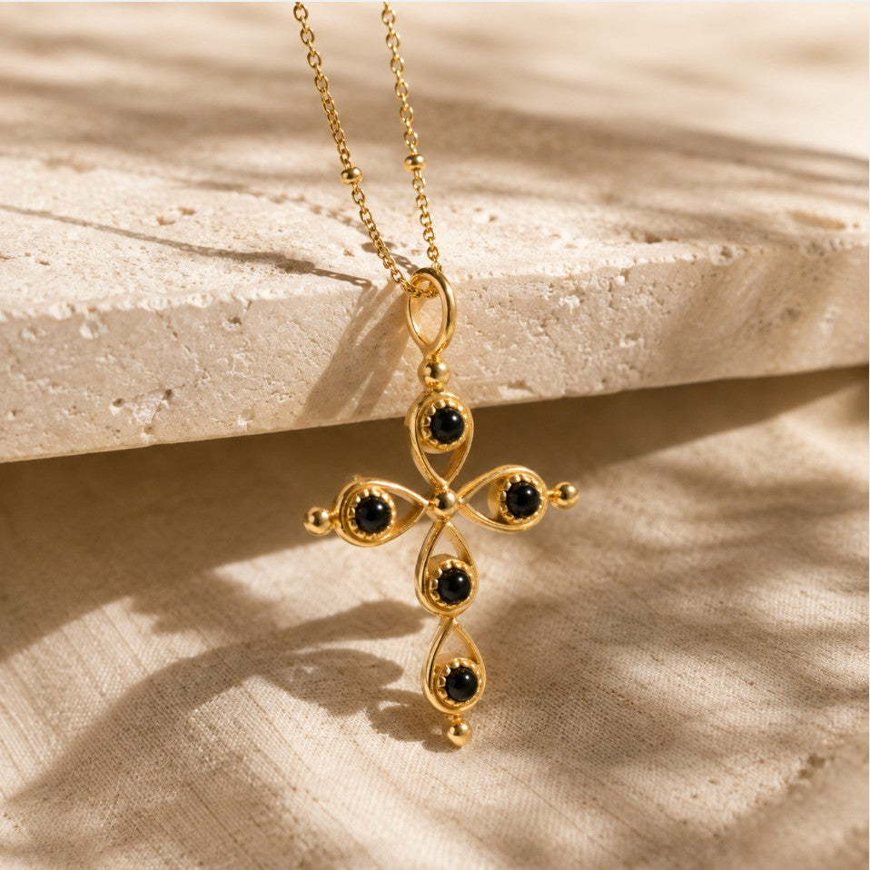 SOWELL JEWELRY 18k gold-plated cross pendant featuring black onyx stones on a delicate ball chain.