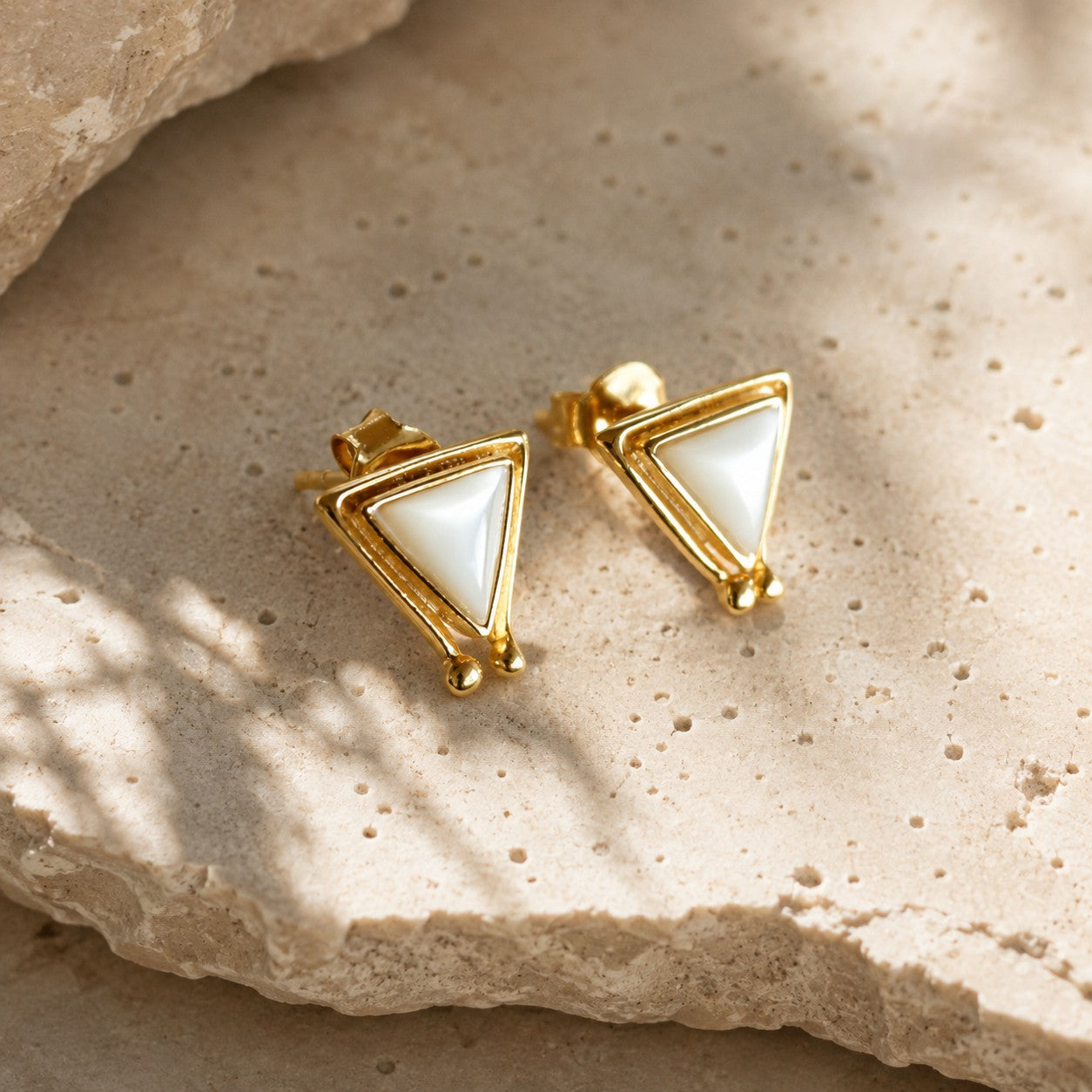 SOWELL JEWELRY Hanale triangle stud earrings featuring iridescent mother of pearl set in 18k gold vermeil.