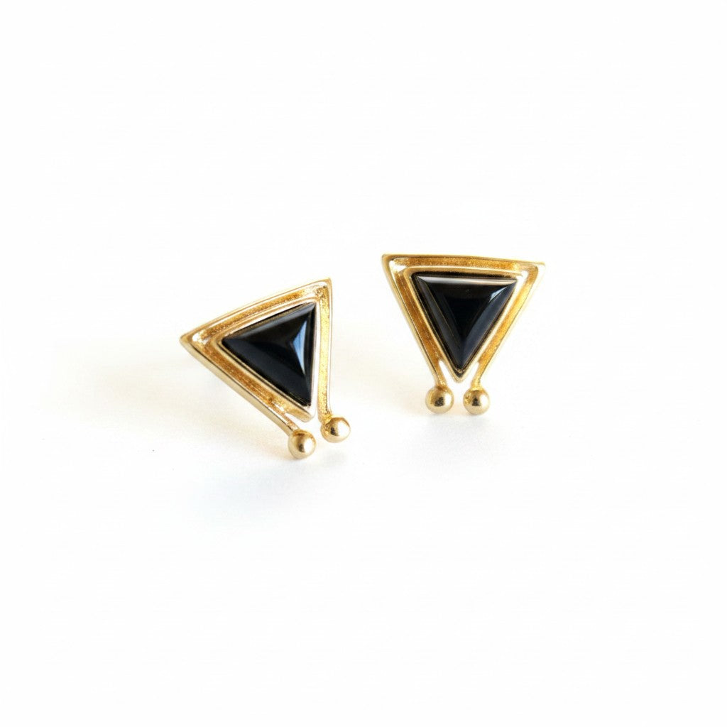 SOWELL JEWELRY Hanale triangle stud earrings featuring black onyx stones set in 18k gold vermeil on a white background.