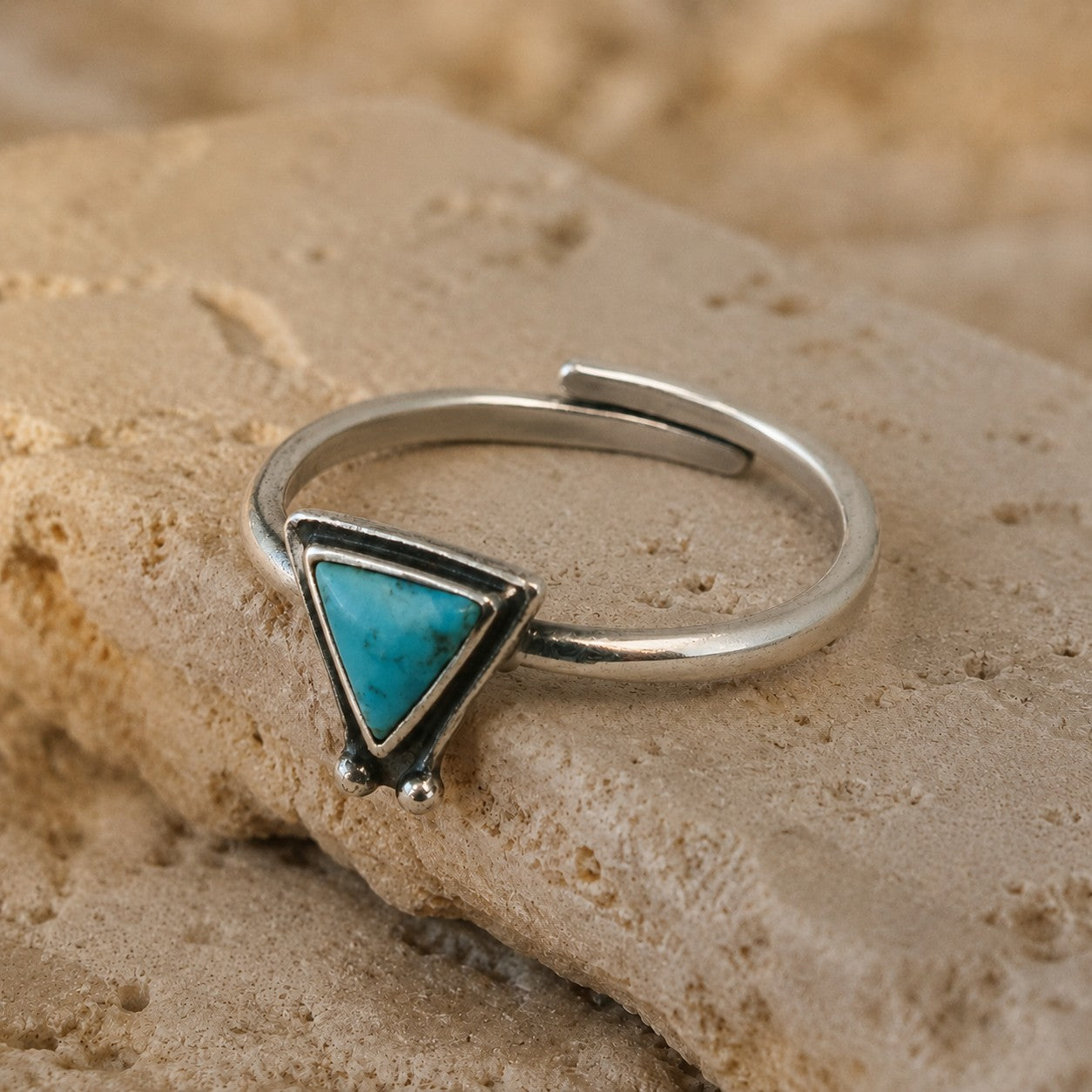 SOWELL JEWELRY Hanale ring featuring a triangular turquoise stone set in polished sterling silver on a stone surface