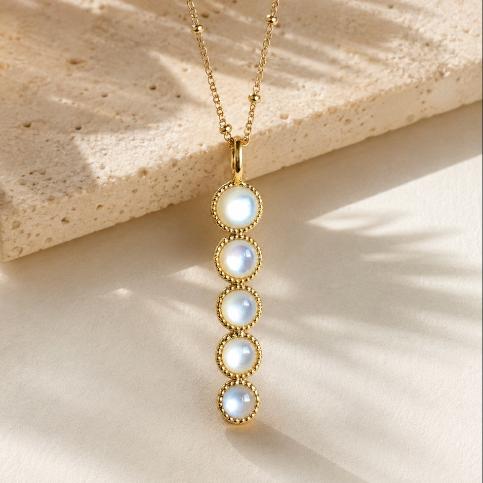 SOWELL JEWELRY Ilaria necklace featuring five round mother of pearl stones in a vertical 18k gold plated setting.
