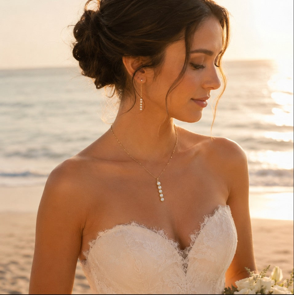 SOWELL JEWELRY Ilaria necklace featuring five mother of pearl stones in 18k gold worn by a bride on a beach.