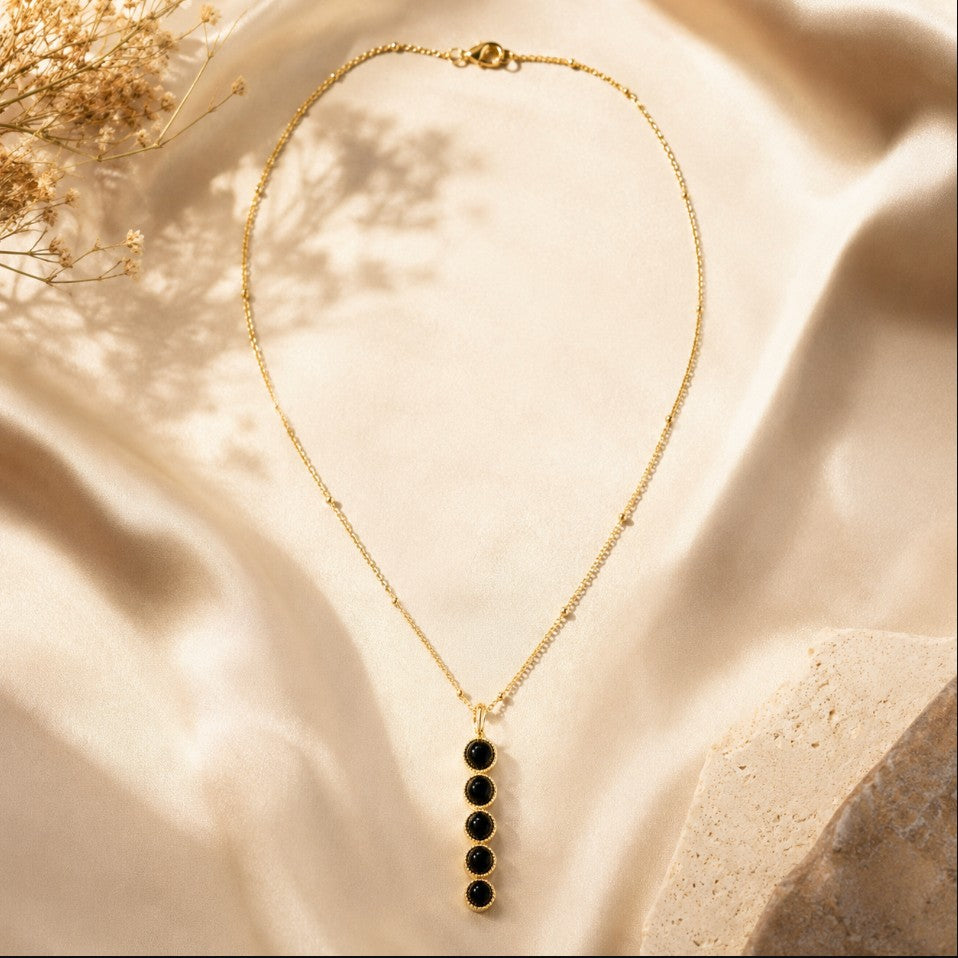 SOWELL JEWELRY Ilaria necklace featuring five round black onyx stones in a vertical 18k gold plated setting