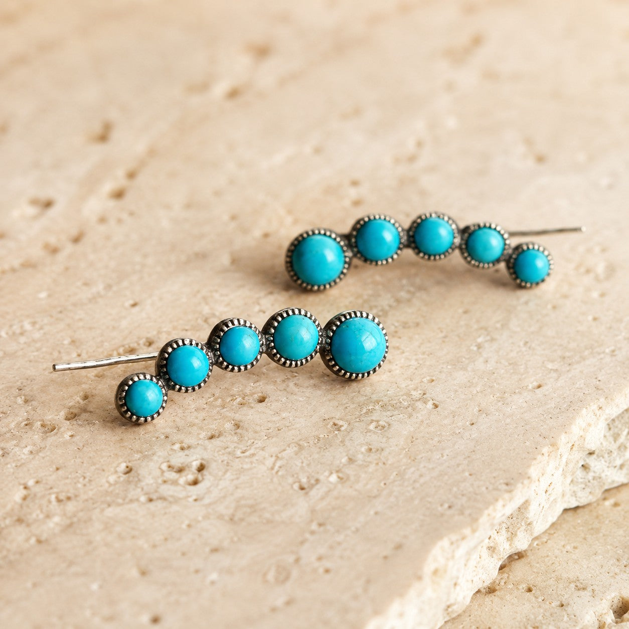 SOWELL JEWELRY Ilaria turquoise earrings featuring five round stones in a sterling silver vertical cascade design.