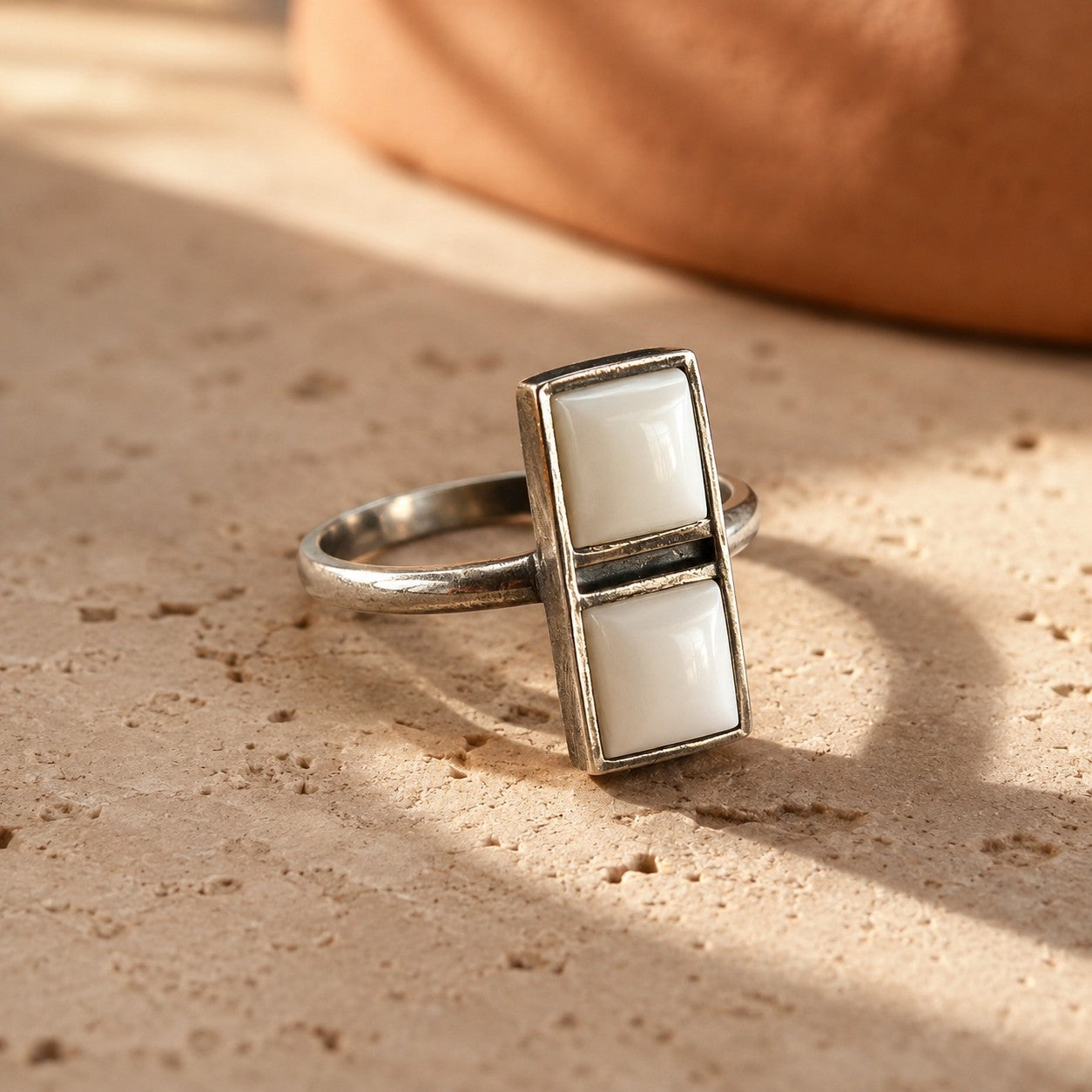 SOWELL JEWELRY Imala ring featuring two white agate stones in a handcrafted sterling silver adjustable band.