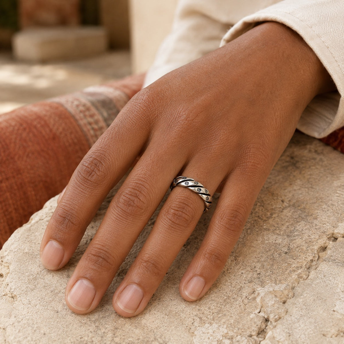SOWELL JEWELRY Isa Silver Band featuring intricate handcrafted sterling silver detail on a model's finger.