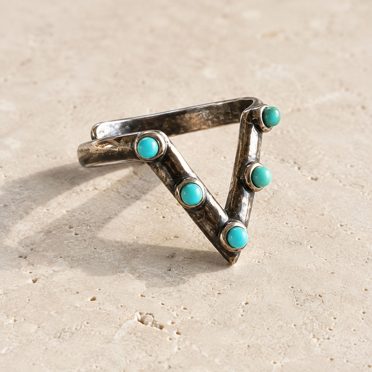 SOWELL JEWELRY Jacy ring featuring five round turquoise stones set in an architectural sterling silver V-shape band.