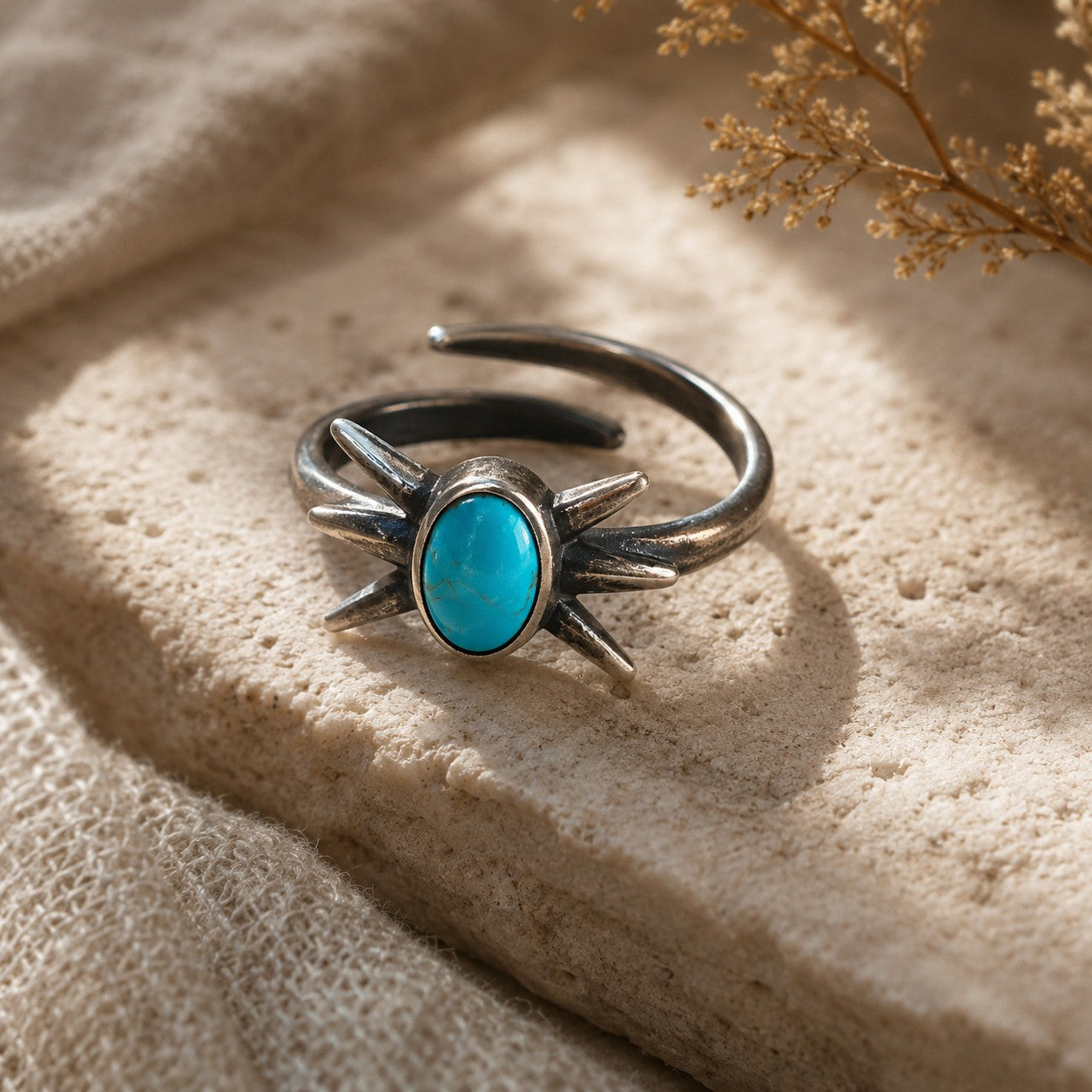 SOWELL JEWELRY Kanti adjustable sterling silver ring with an oval turquoise stone and starburst prong setting.