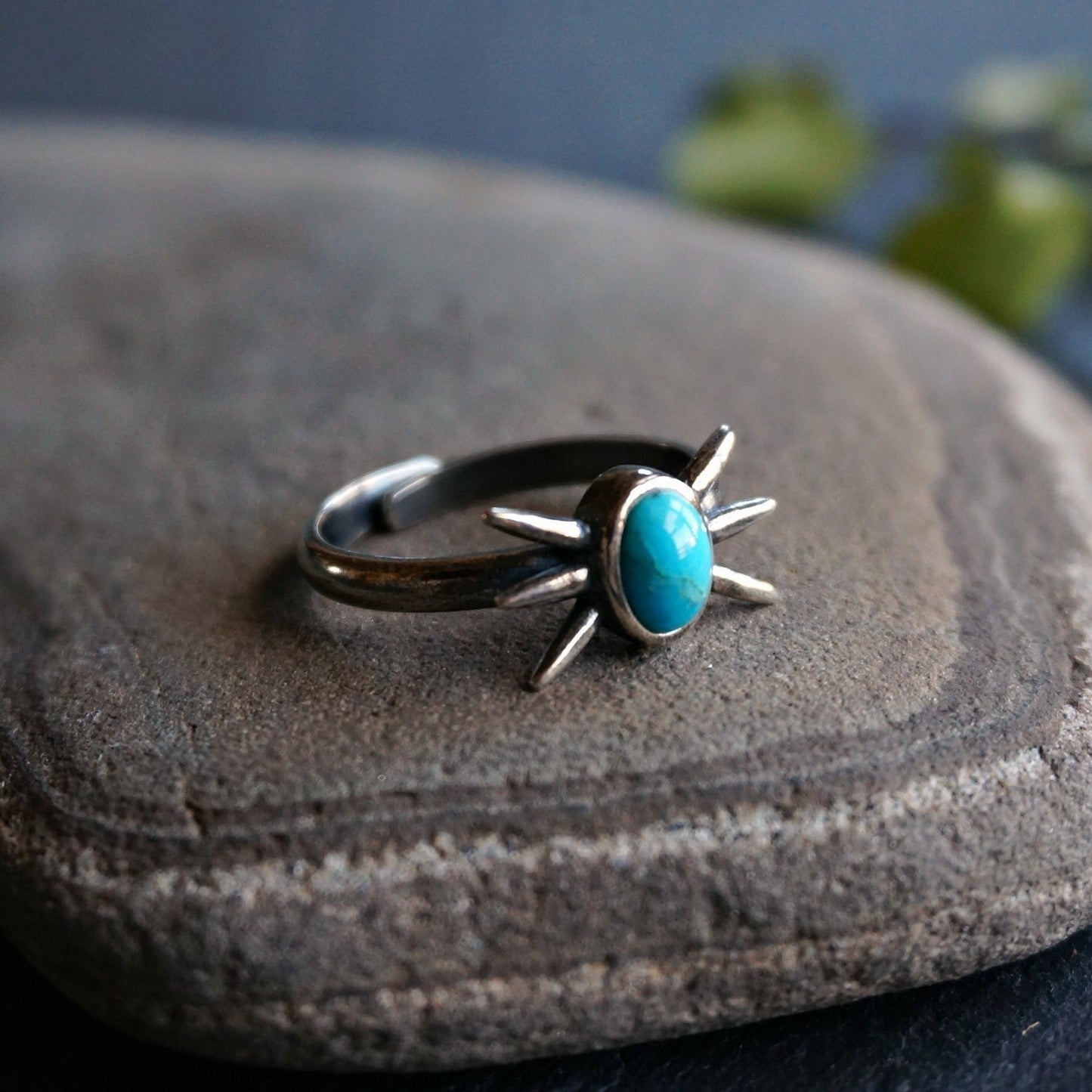 SOWELL JEWELRY Kanti ring featuring an oval turquoise stone set in darkened sterling silver with starburst prongs.