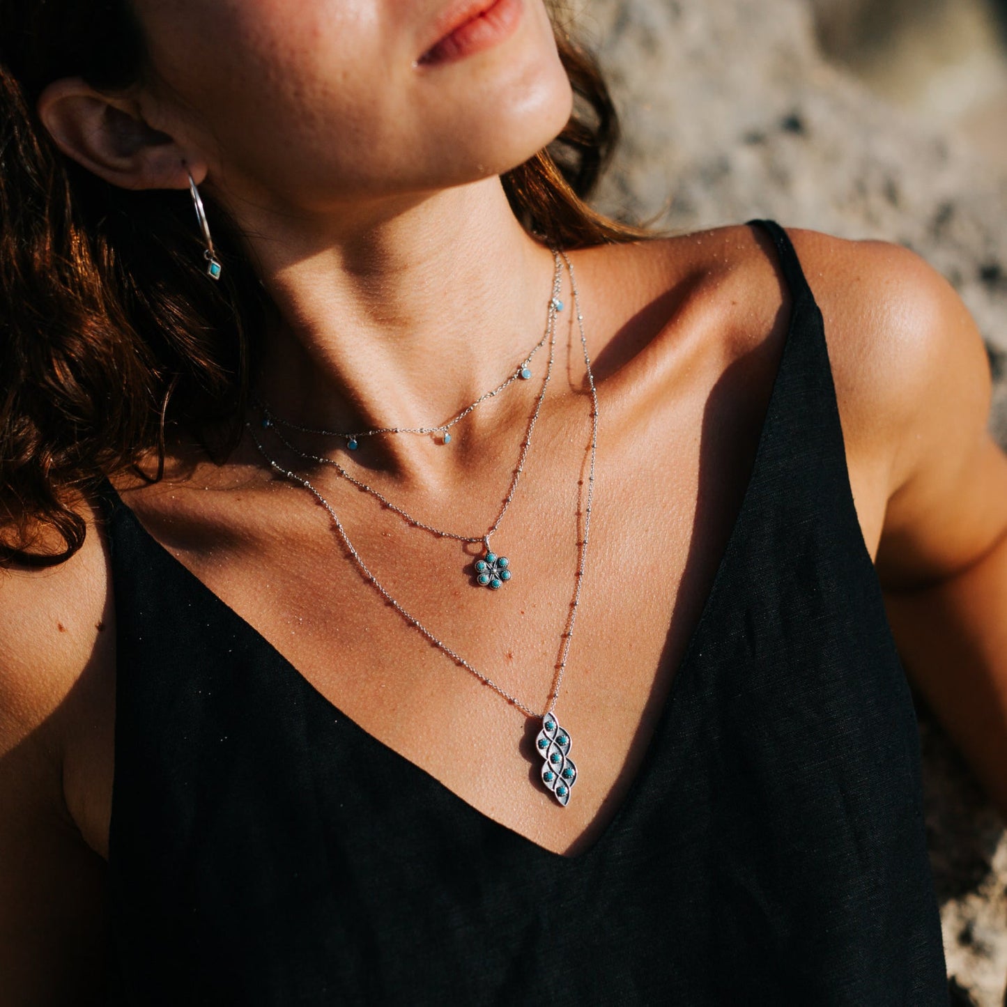 SOWELL JEWELRY Lucia necklace featuring turquoise stones in an oxidized sterling silver lattice pendant on a model