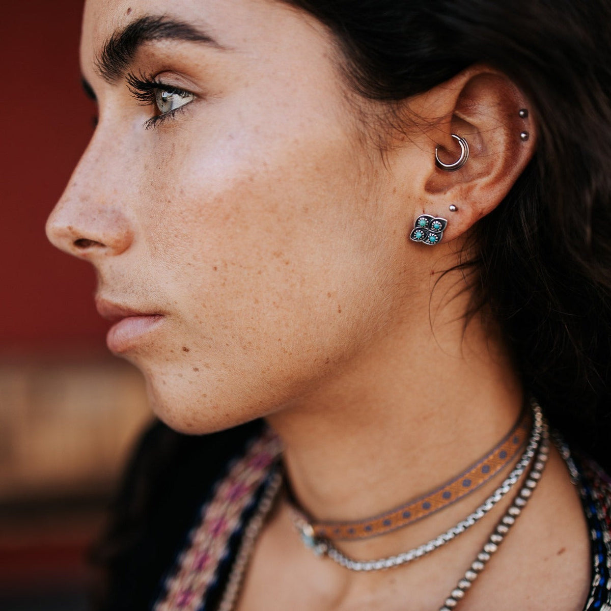 SOWELL JEWELRY Lucia stud earrings featuring turquoise stones set in textured sterling silver worn by a model