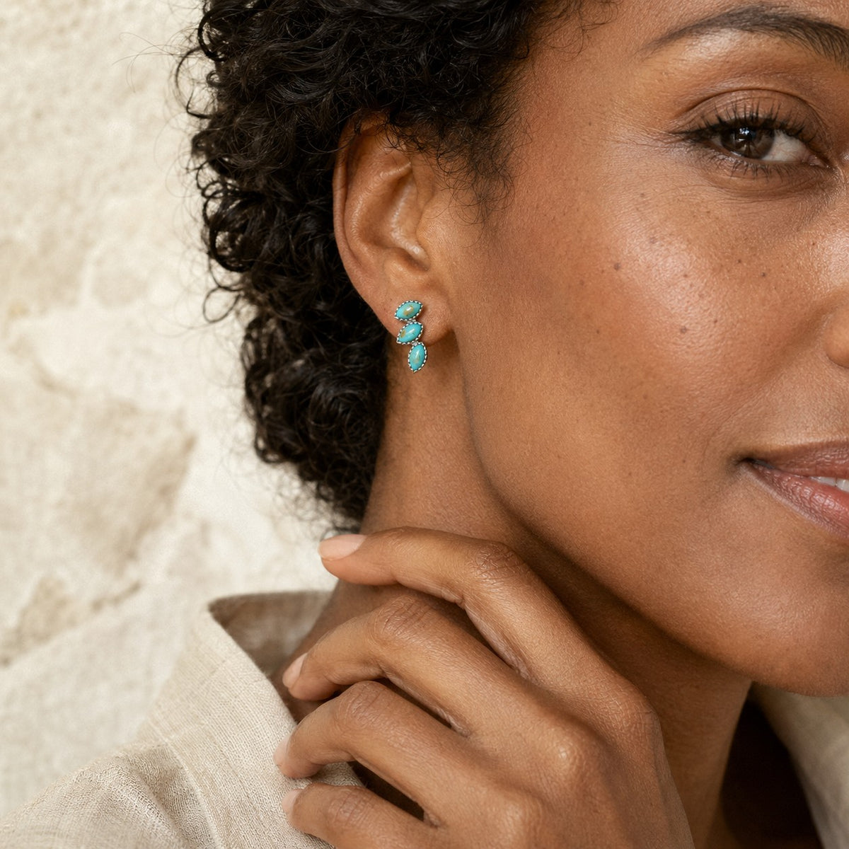 SOWELL JEWELRY Lyra turquoise earrings featuring three marquise stones in sterling silver worn by a woman
