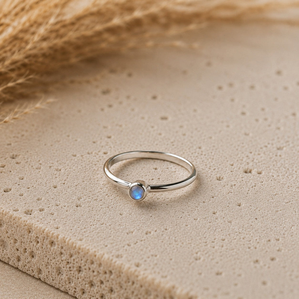 SOWELL JEWELRY minimalist ring featuring a bezel-set rainbow moonstone on a thin sterling silver band