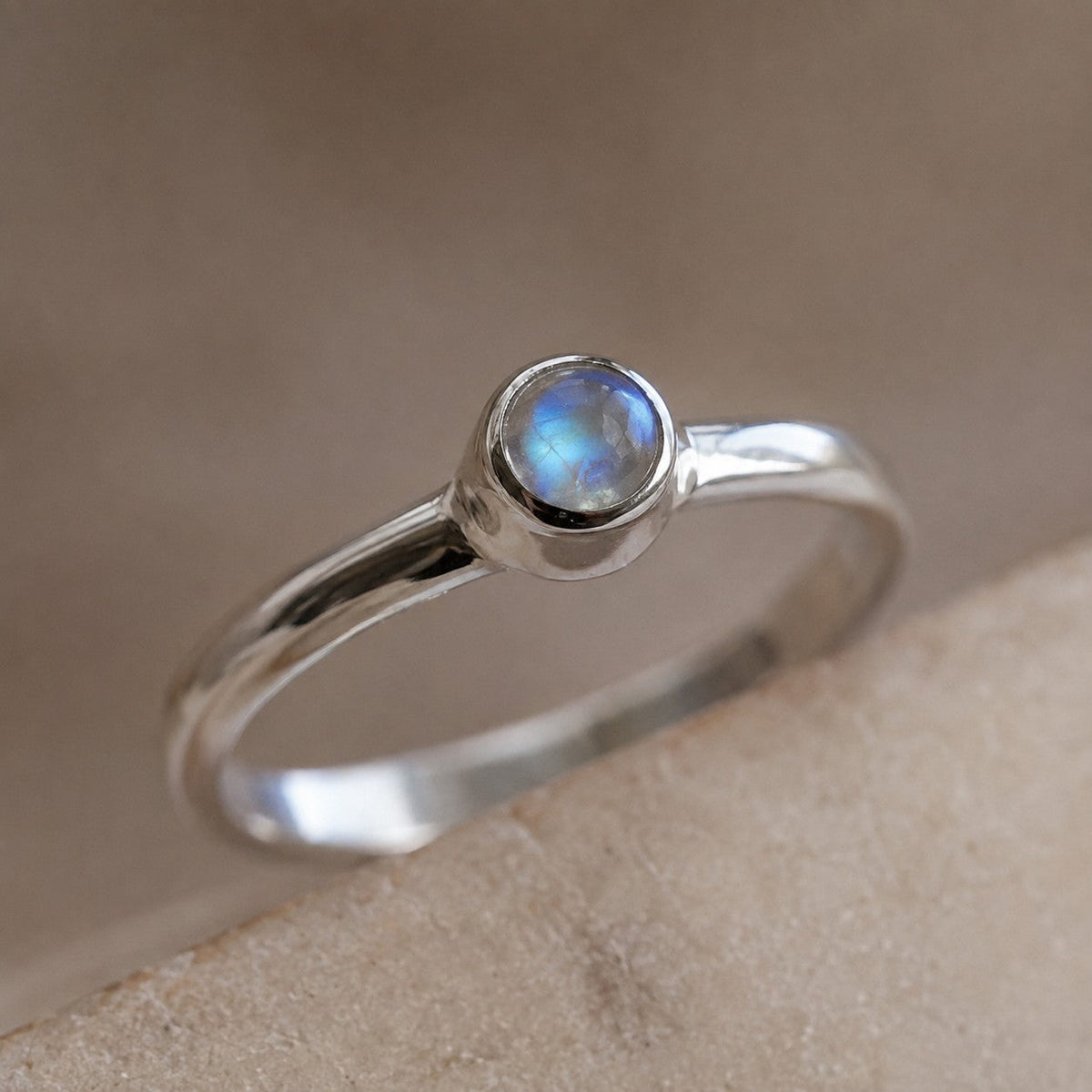 SOWELL JEWELRY minimalist ring featuring a bezel-set rainbow moonstone in polished .925 sterling silver