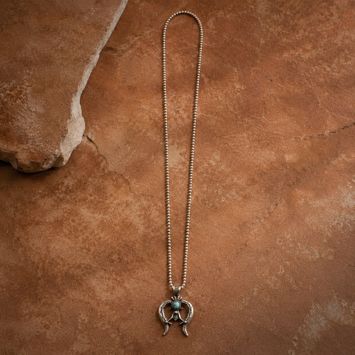 SOWELL JEWELRY Naja statement necklace featuring a hand-forged sterling silver crescent pendant with Kingman turquoise.