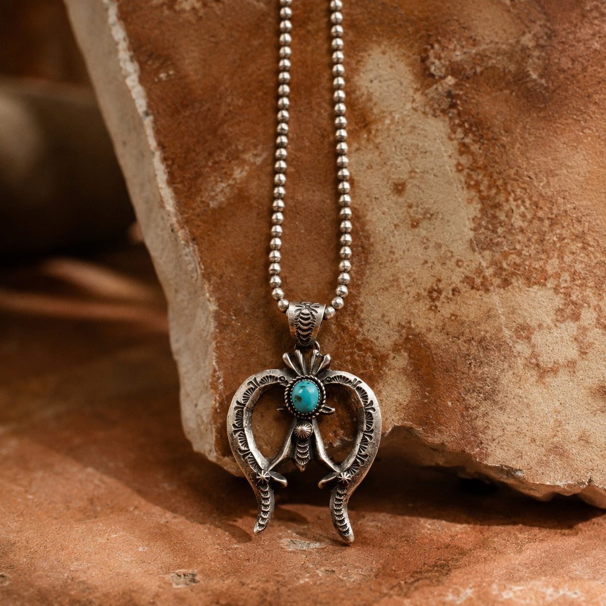 SOWELL JEWELRY hand-forged sterling silver Naja statement necklace with a Kingman turquoise stone on a bead chain.