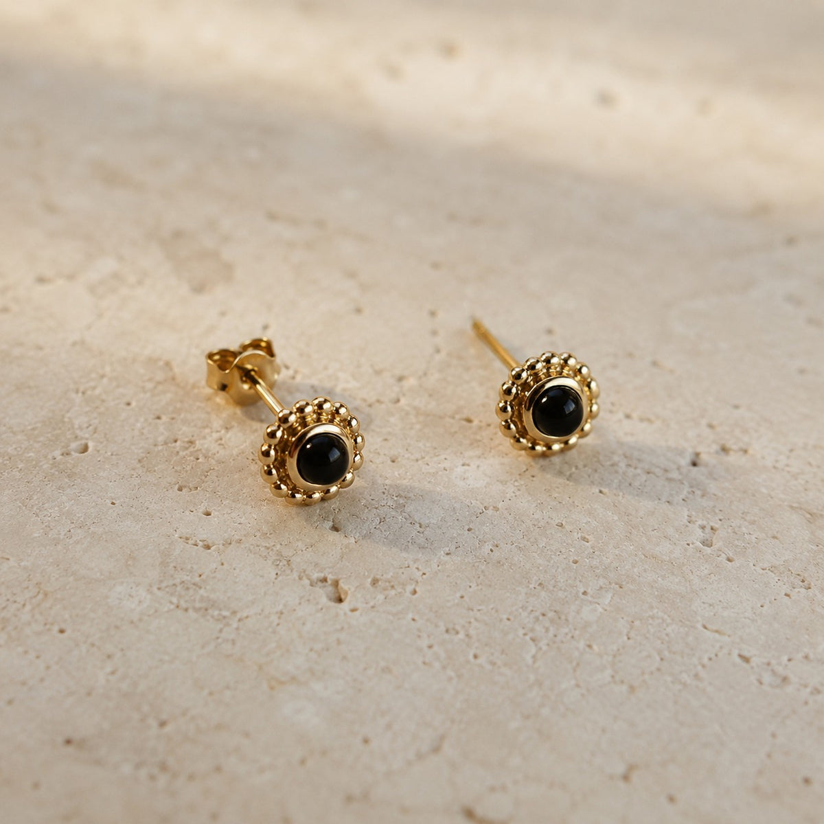 SOWELL JEWELRY Maya stud earrings featuring genuine black onyx stones set in 18k gold vermeil with beaded edges.