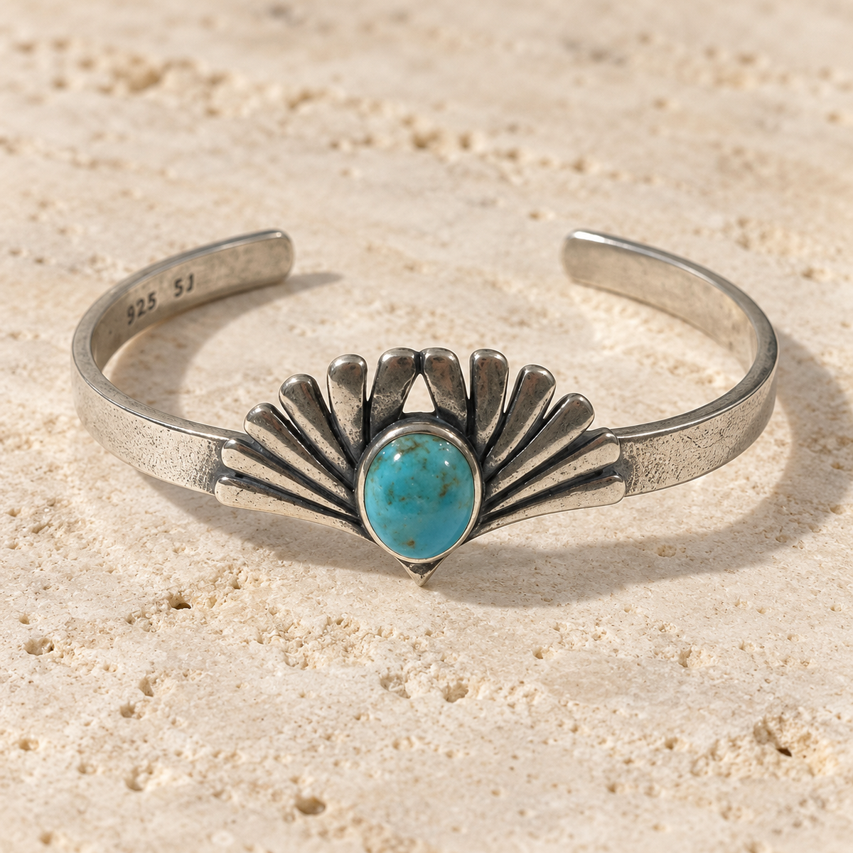 SOWELL JEWELRY Prayer cuff bracelet in sterling silver with a central turquoise stone and botanical leaf design.