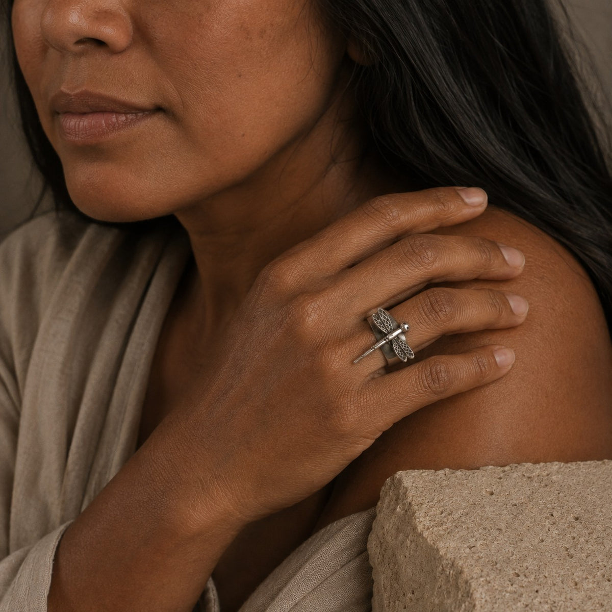 SOWELL JEWELRY handcrafted sterling silver dragonfly ring worn on a woman's finger with an adjustable design.