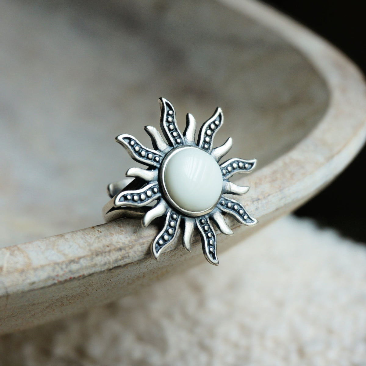 SOWELL JEWELRY sterling silver sunburst ring featuring a central white agate stone with detailed ray accents.