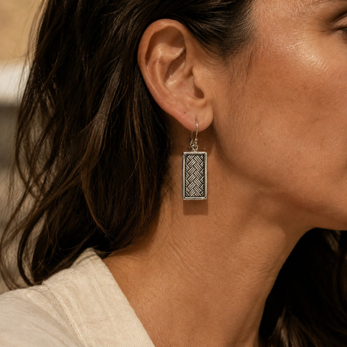 SOWELL JEWELRY Tao sterling silver earrings featuring a rectangular woven basket pattern on a model