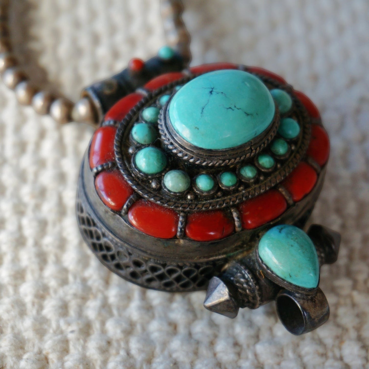SOWELL JEWELRY Tibetan Gau prayer box pendant in sterling silver with natural turquoise and coral inlay on bead chain