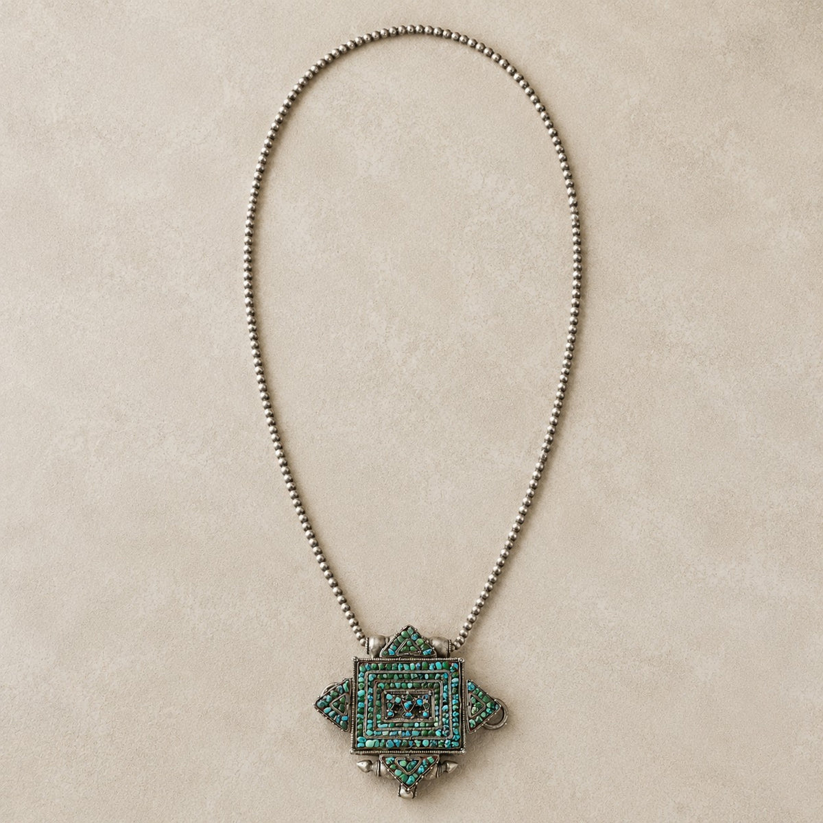 SOWELL JEWELRY Tibetan gau box pendant featuring a turquoise mosaic on sterling silver with a beaded chain.