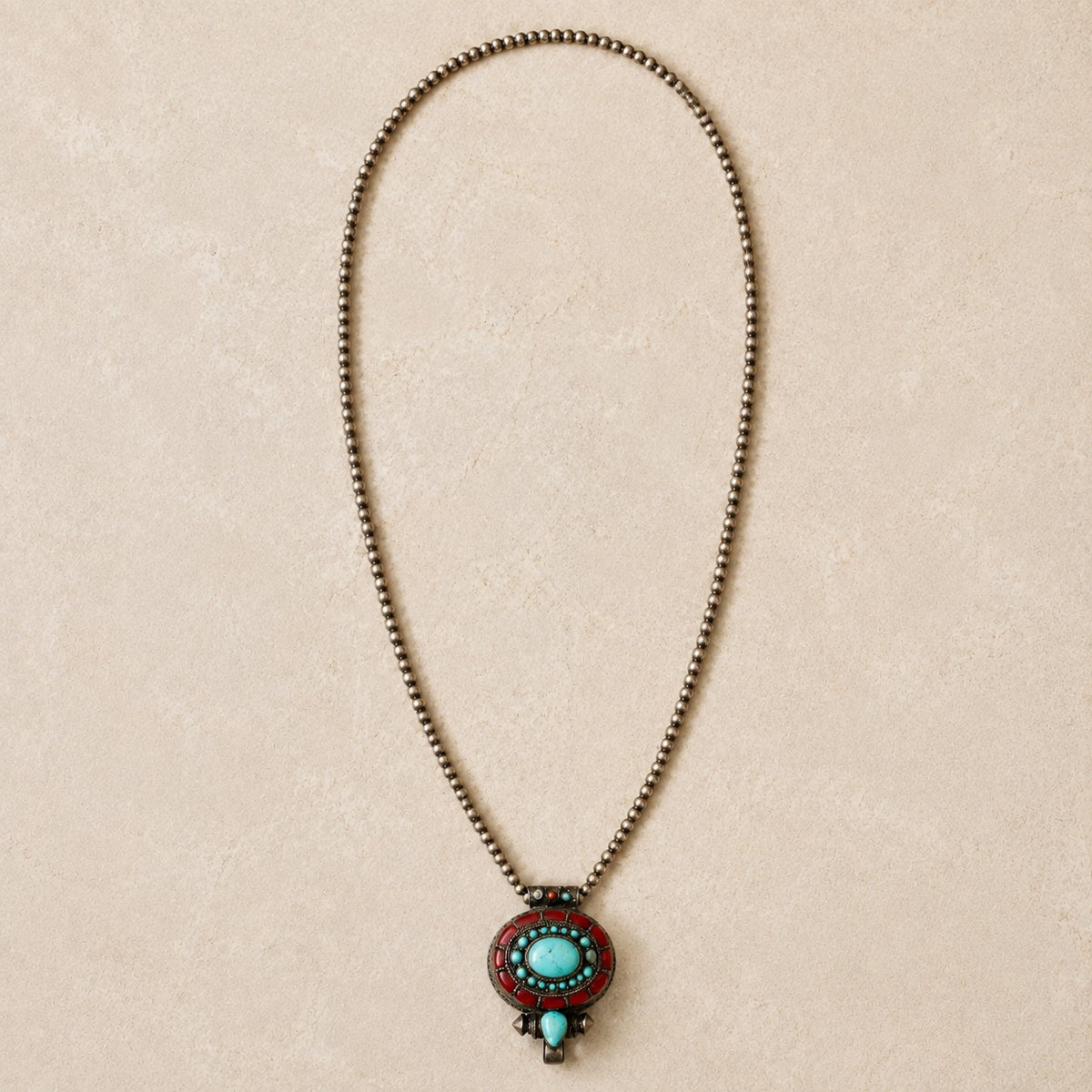 SOWELL JEWELRY Tibetan prayer box pendant featuring turquoise and coral inlay on sterling silver with bead chain.