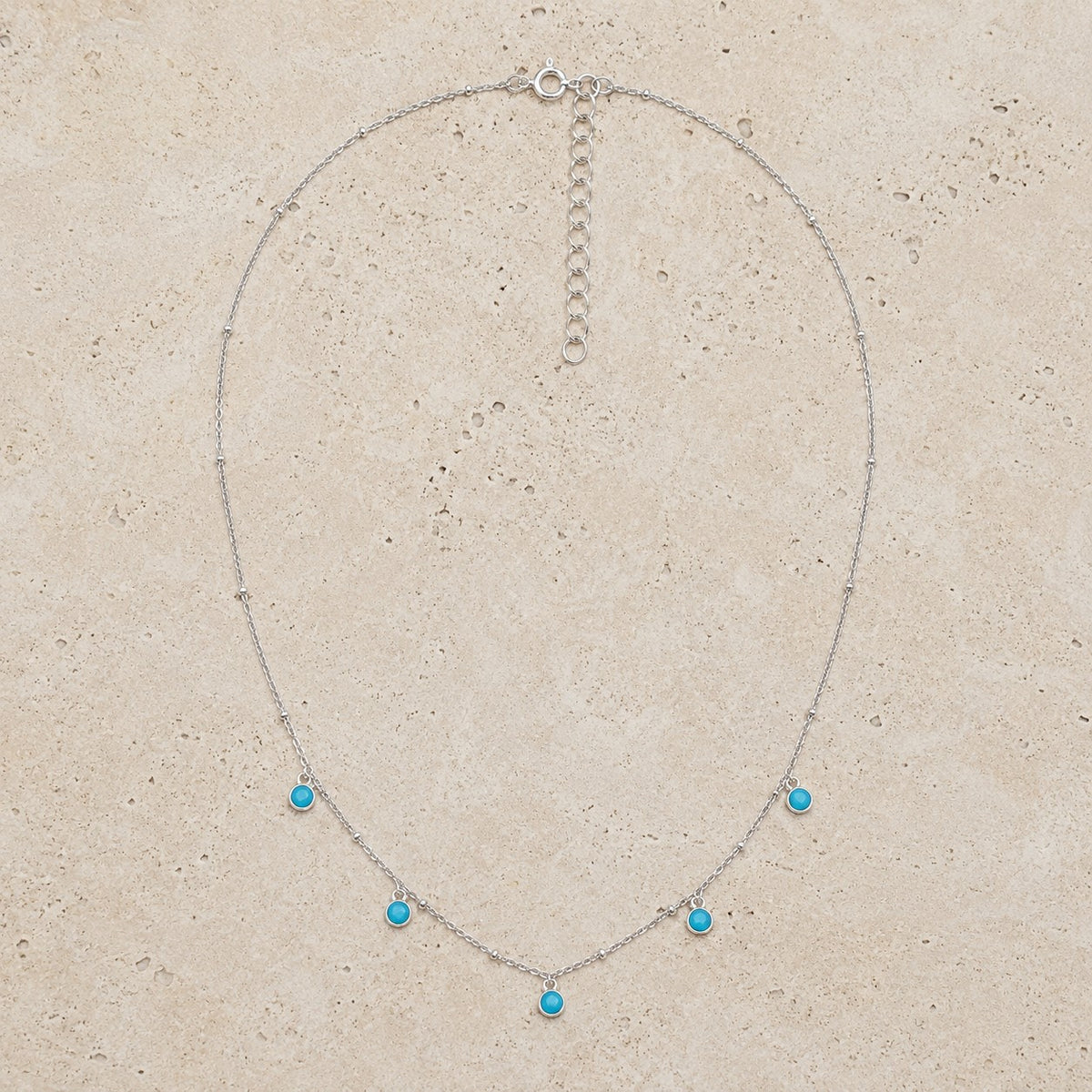 SOWELL JEWELRY delicate silver-tone beaded chain necklace featuring five dainty bezel-set turquoise stones.