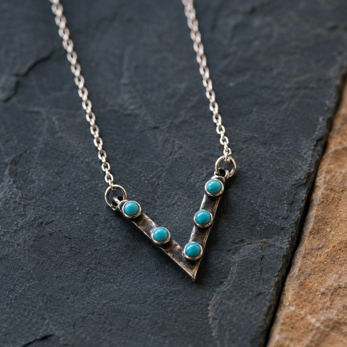 SOWELL JEWELRY Jacy chevron necklace featuring five round turquoise stones set in oxidized sterling silver.