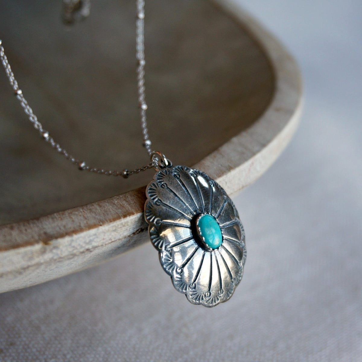 SOWELL JEWELRY Abeytu turquoise concho necklace with hand-stamped sterling silver pendant on a delicate silver chain.