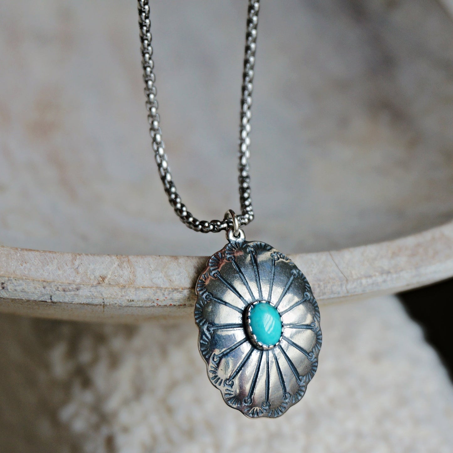 SOWELL JEWELRY Abeytu turquoise concho necklace with a hand-stamped sterling silver pendant on a silver chain.