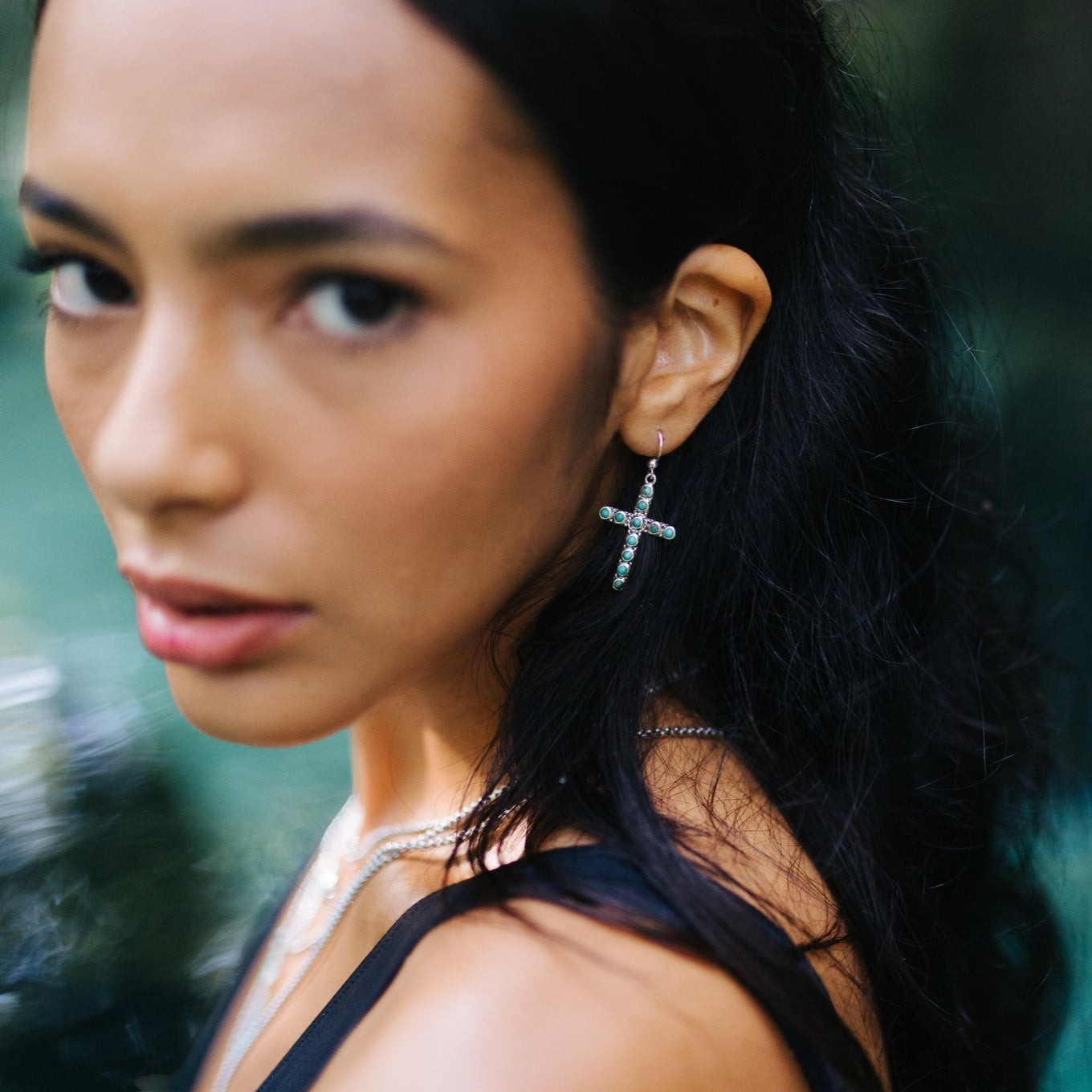 Model wearing SOWELL JEWELRY Giada turquoise cross earrings in sterling silver with a boho southwestern style