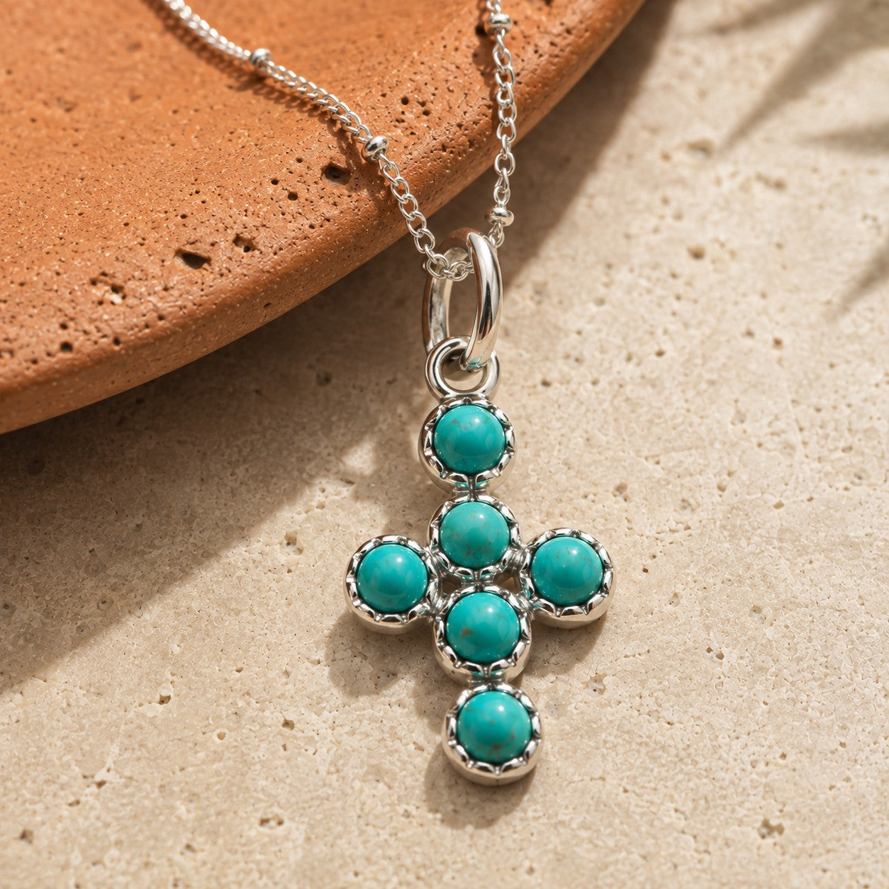 SOWELL JEWELRY Desert Cross pendant featuring genuine turquoise stones set in solid sterling silver on a delicate chain.