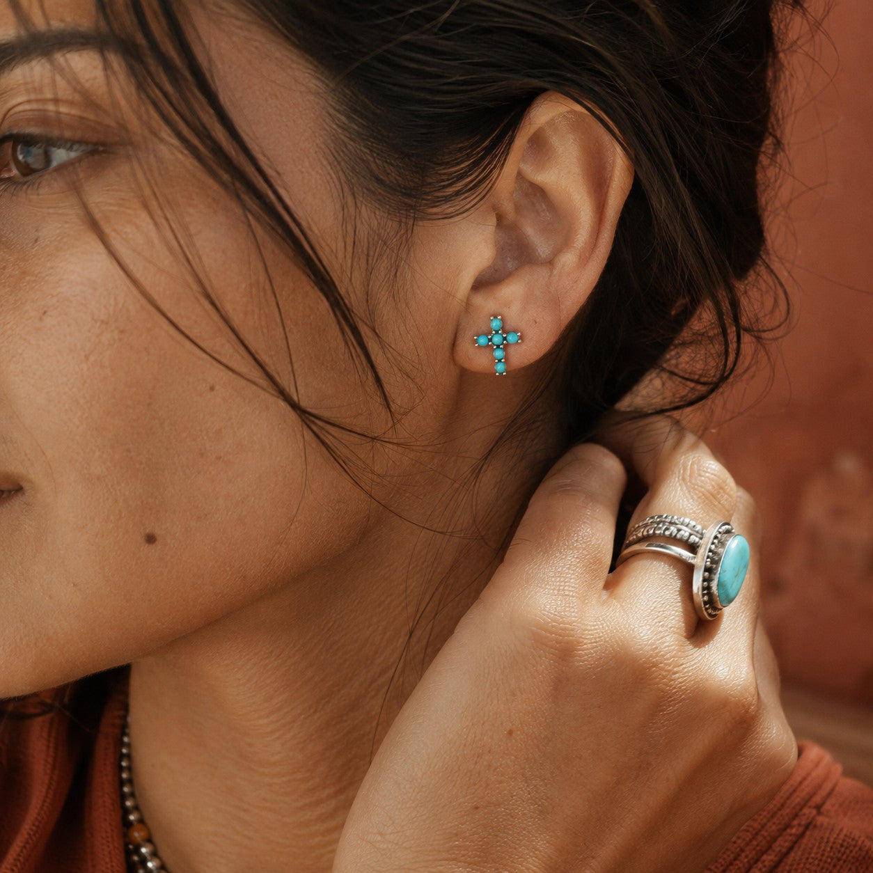 SOWELL JEWELRY turquoise cross stud earrings in sterling silver worn by a woman with a matching turquoise ring
