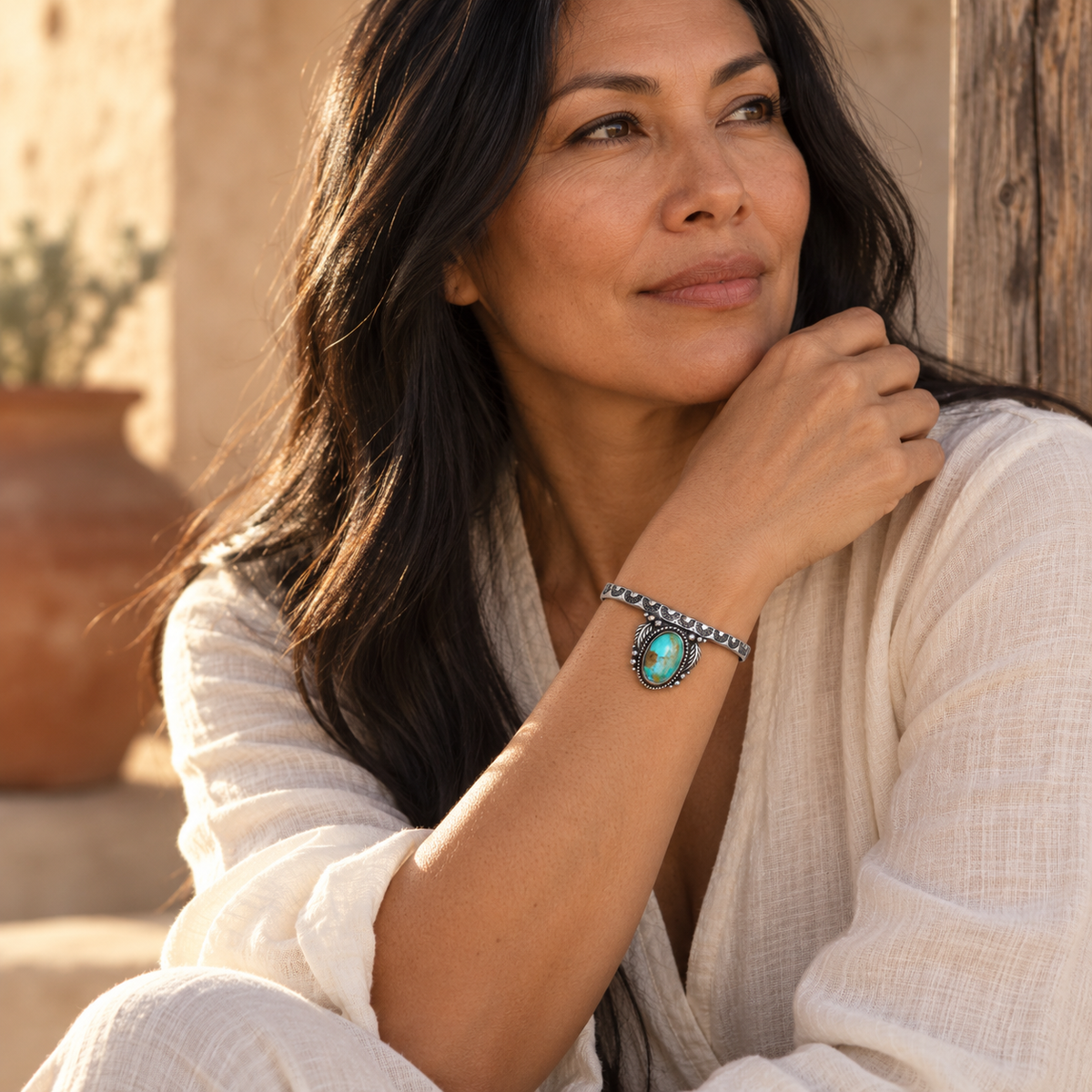 SOWELL JEWELRY Abai turquoise cuff bracelet in sterling silver worn by a woman in a desert setting