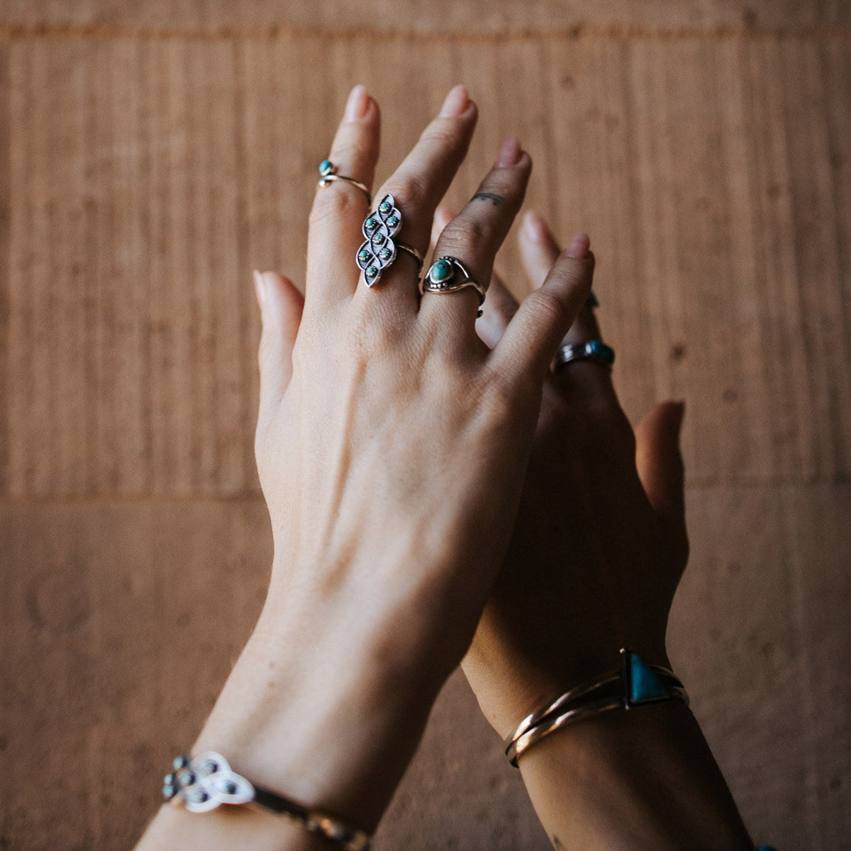 SOWELL JEWELRY sterling silver evil eye ring with turquoise stone worn on a hand with other silver jewelry