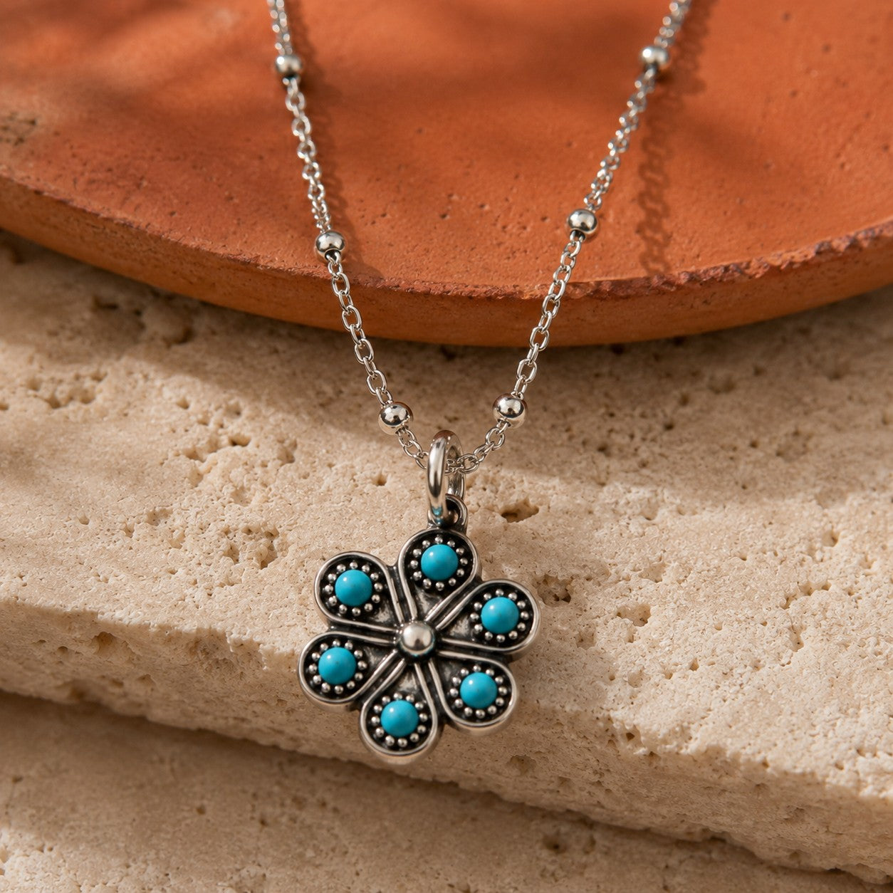 SOWELL JEWELRY Iris flower necklace featuring genuine turquoise stones set in handcrafted .925 sterling silver.